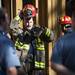 A firefighter takes off his helmet after coming out of a building at 611 Church Street on Monday. Daniel Brenner I AnnArbor.com